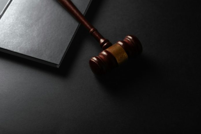 A judge's gavel resting beside a law book