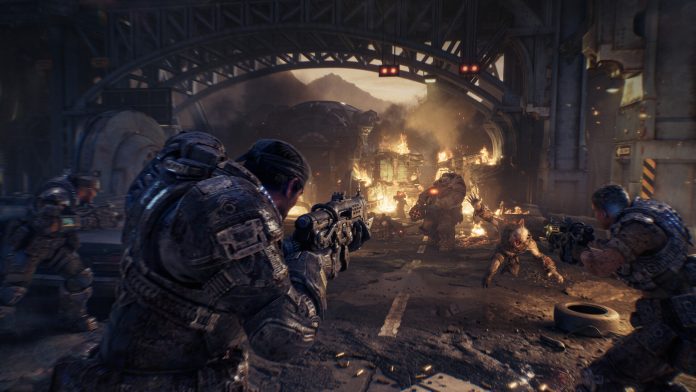 Marcus Fenix fighting in a burning street in a Gears of War: E-Day screenshot