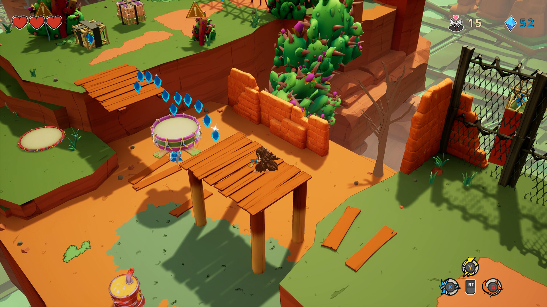 A drum and wooden platforms among red rock and cactus in a Kalanoro screenshot