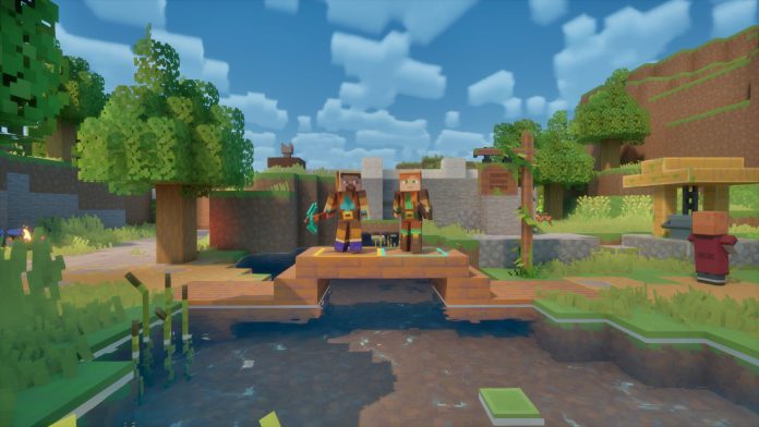Two heroes stand on a wooden bridge near a village in a Minecraft Dungeons II screenshot