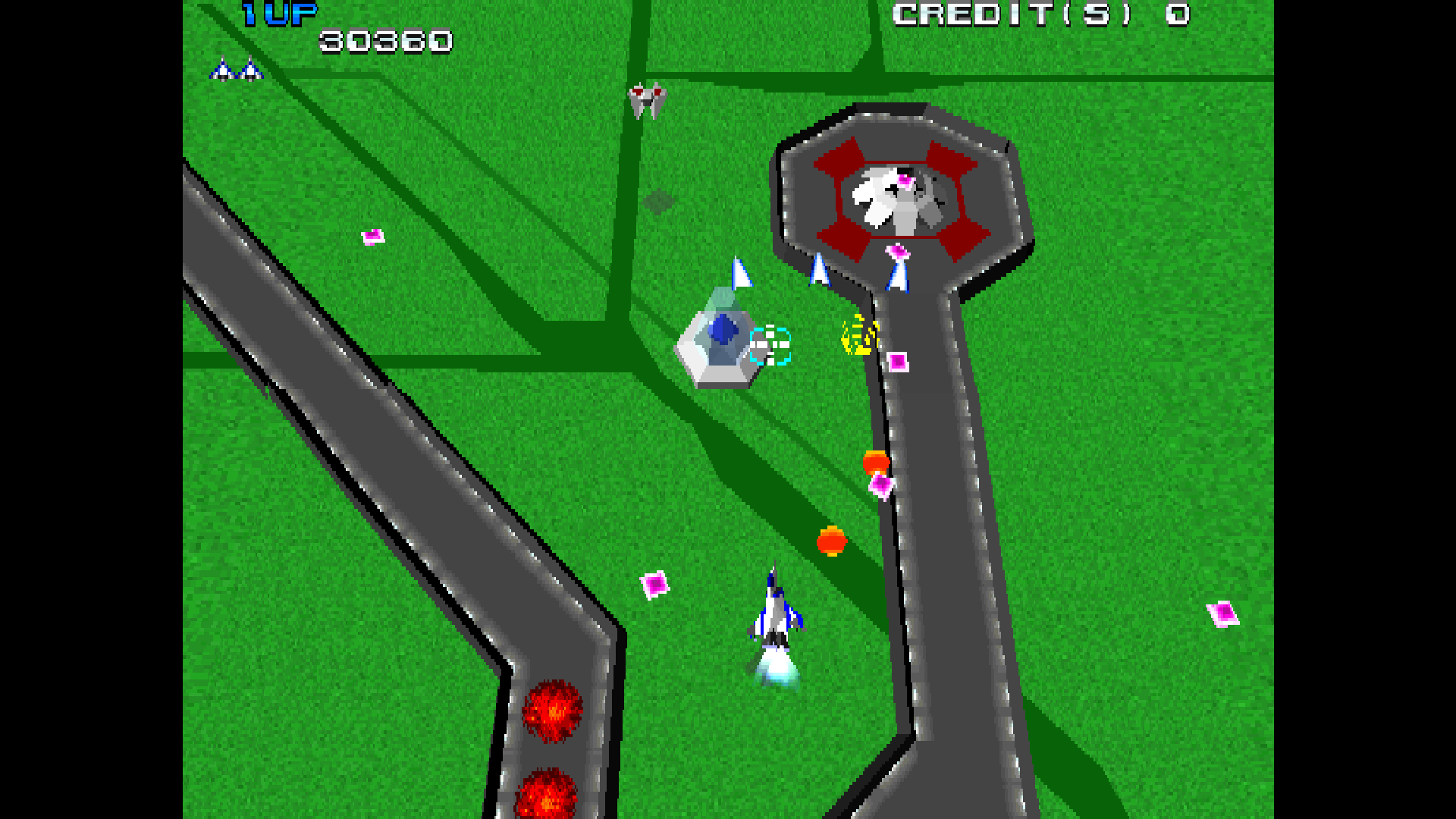 A Xevious 3D/G screenshot showing the Solvalou over green terrain