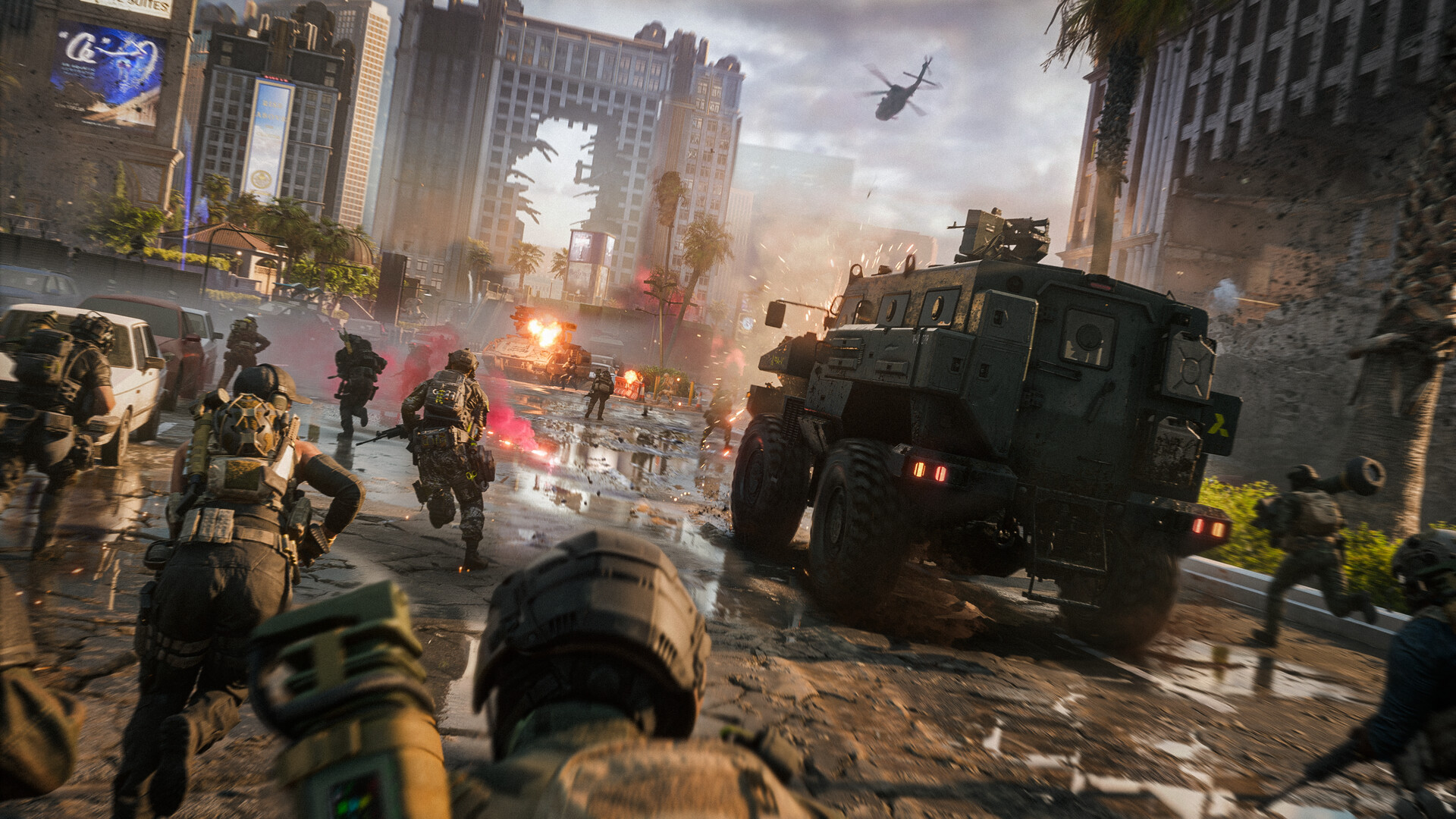 Battlefield 6. Soldiers advance down a wrecked Las Vegas street behind an armoured truck, with a helicopter overhead.