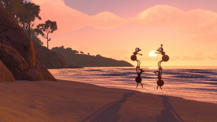 Two players stacked into wobbly towers on a beach at sunset, with bushy headland behind