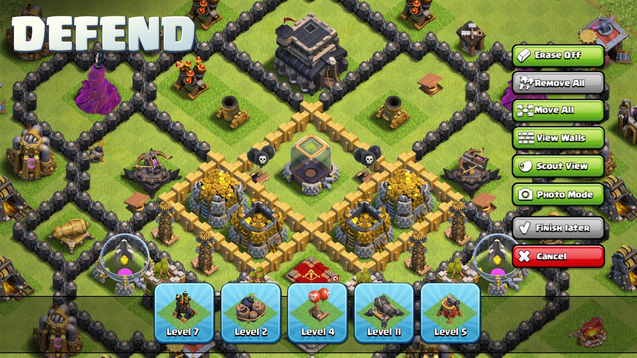 A Clash of Clans layout editor screen titled Defend, showing a village with buttons including Erase Off, Remove All, Move All, Photo Mode and Finish later, and defence cards along the bottom.