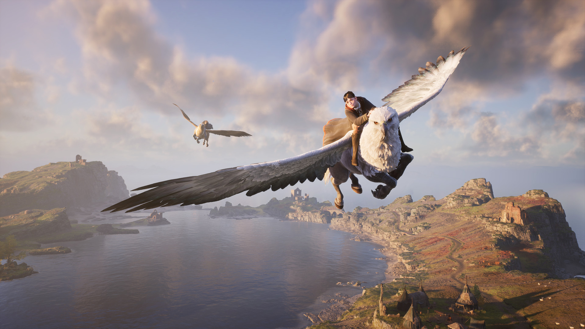 A student riding a white-headed hippogriff over a rocky coastline and a lake in Hogwarts Legacy, with a second flier in the distance.