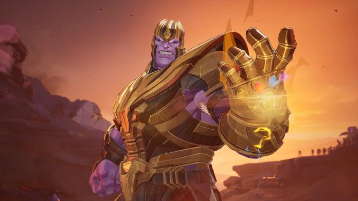 A Marvel Rivals screenshot of Thanos in golden armour holding up the Infinity Gauntlet against an orange sky.