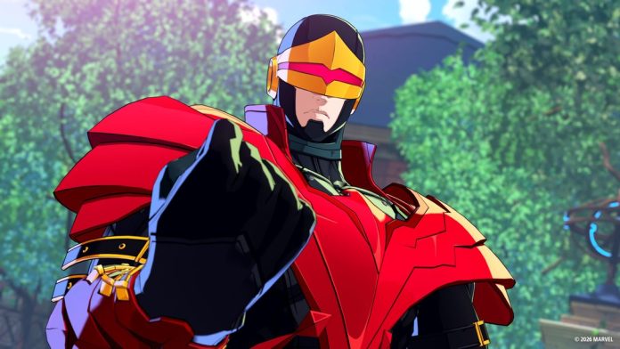Phoenix Cyclops in a red and gold costume with a visor, pointing at the viewer in front of a leafy campus