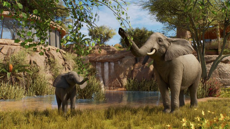 An adult elephant and a calf beside a pond with a small waterfall and acacia-style trees in a Planet Zoo 2 enclosure