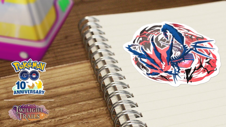 An Eternatus sticker on a spiral notebook beside the Pokémon GO 10th Anniversary logo