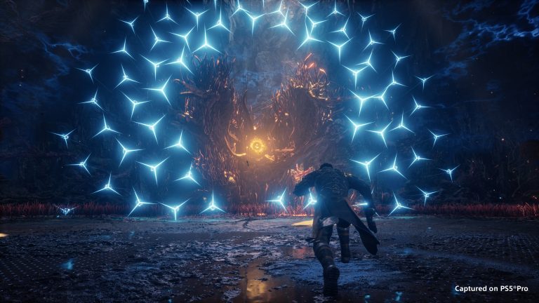 A lone figure runs toward a glowing orange core in a cave as a ring of blue star-shaped projectiles surrounds it, captured on PS5 Pro.