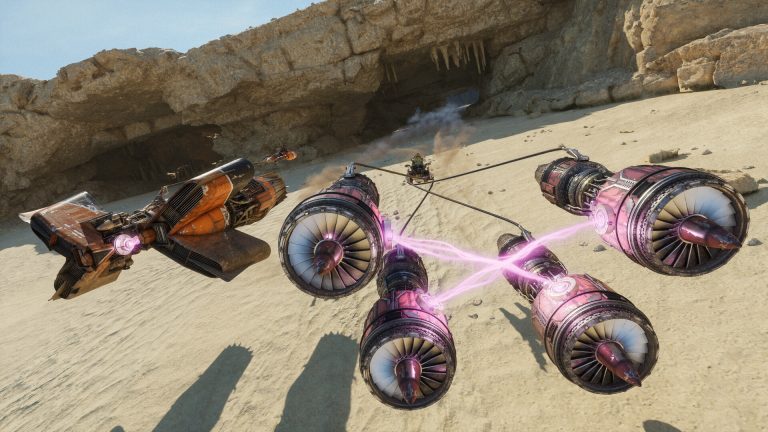 A purple-glowing podracer with four engines and an orange skim speeder race through a sandy canyon with a cave behind them