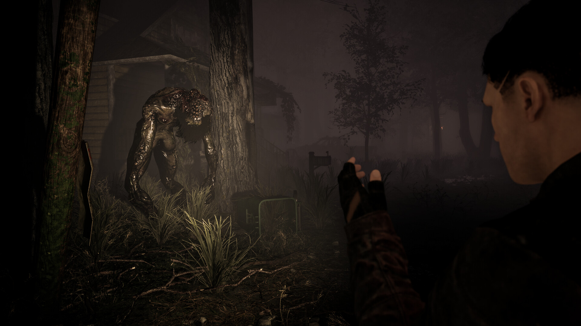 Surrounded: a hunched creature stands between trees beside a player holding a torch.
