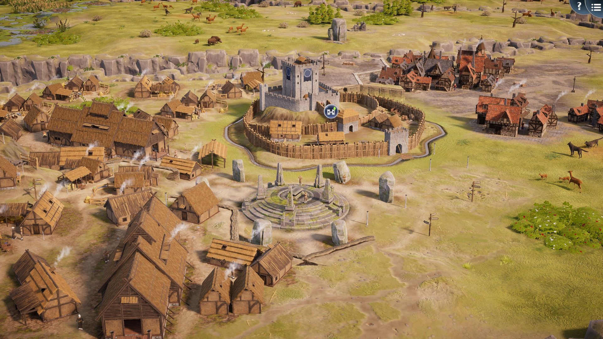 An elevated view of a medieval village in TerraScape, with thatched wooden buildings around a stone circle and a timber-fenced castle keep on a grassy hill