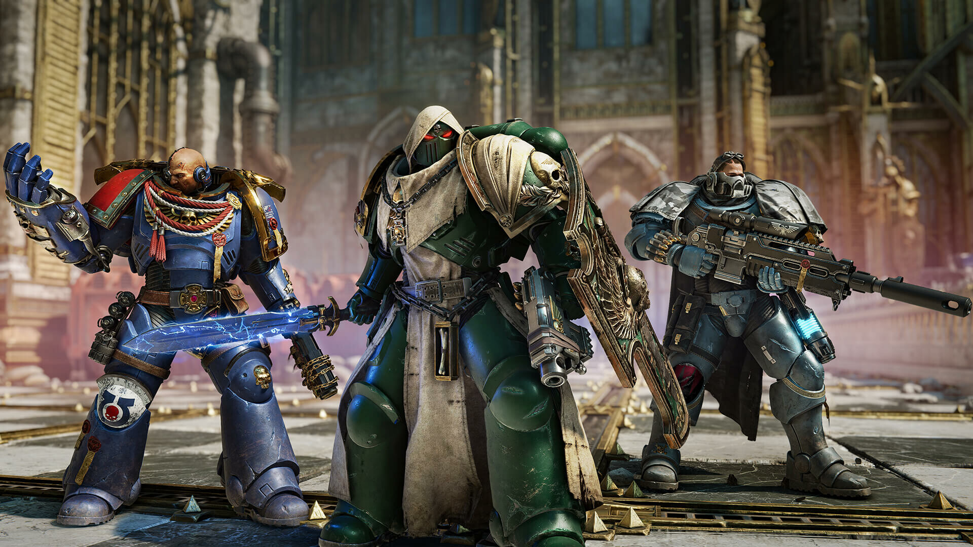 Three Space Marines in blue, green and grey armour stand ready for battle inside a gothic cathedral